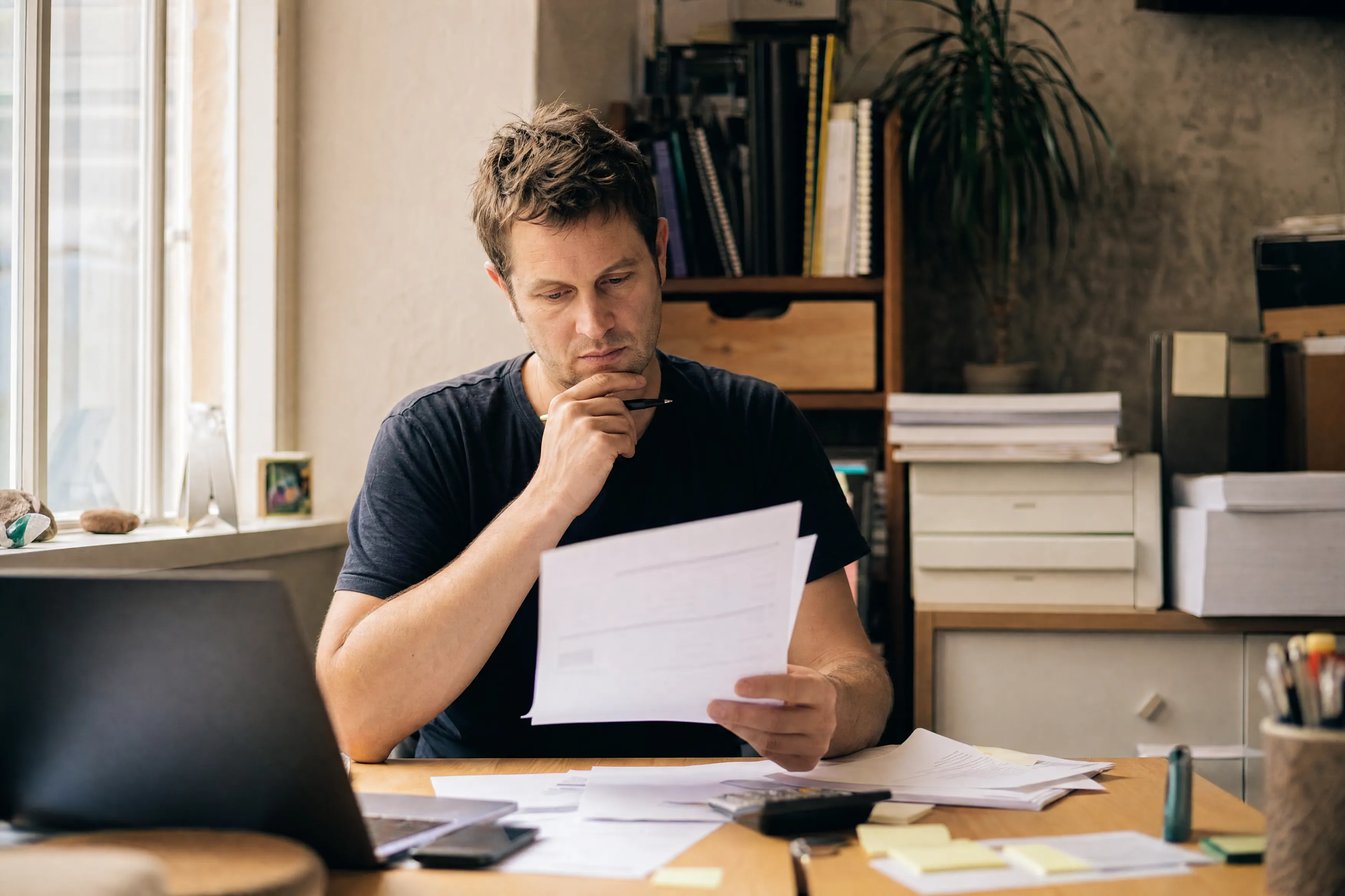 Business owner reviewing tax obligations at his desk