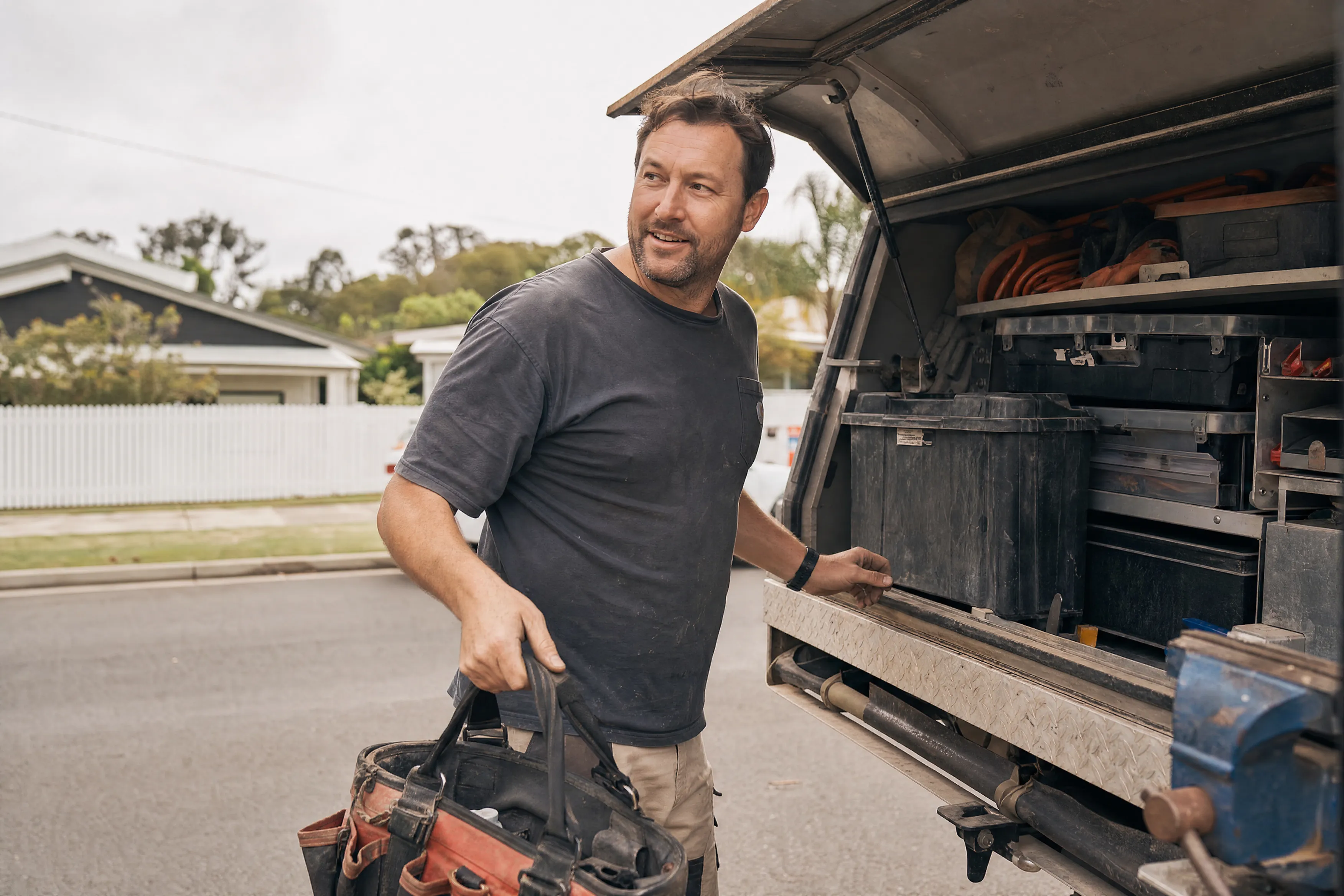 Tradie loading tools into a financed work ute