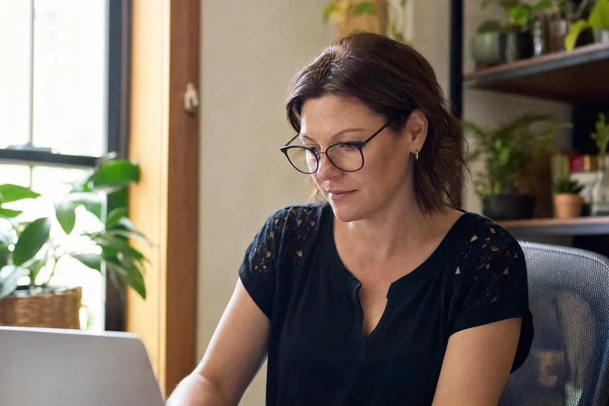 Business owner going over her monthly figures at her desk