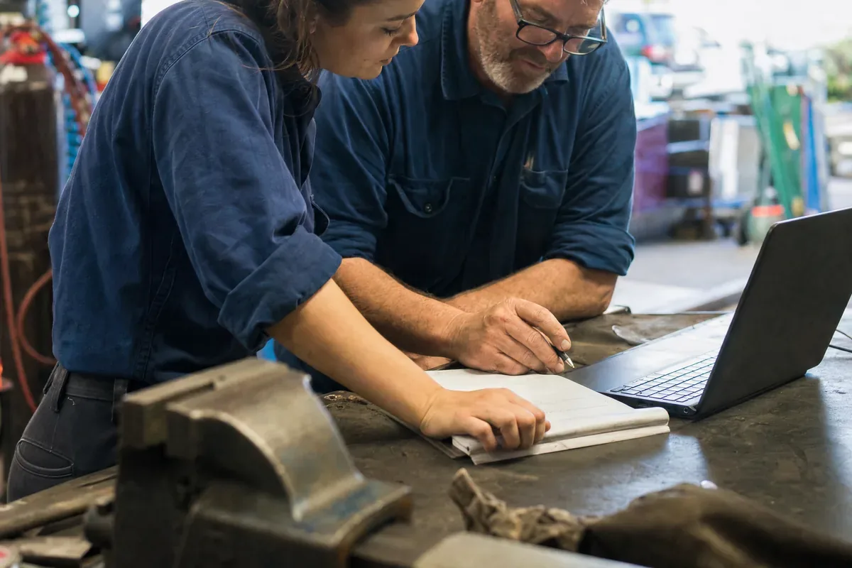 Workshop owners going over their numbers together